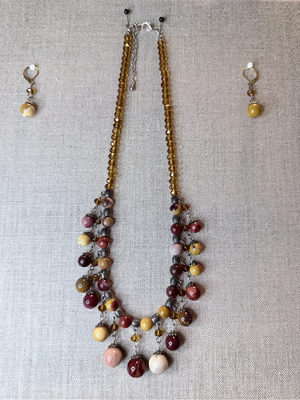 This is a handcrafted multi-strand cluster beaded necklace & matching ear rings
